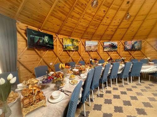a dining room with a long table and chairs at Eco Resort Kaiyrma in Bokonbayevo