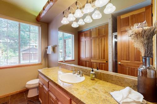a bathroom with a sink and a toilet and a mirror at Cochise Adventures in South Lake Tahoe