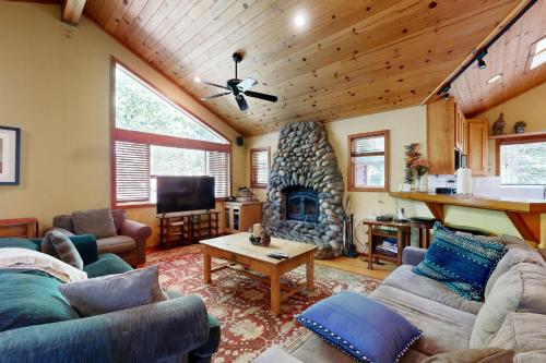 a living room with couches and a stone fireplace at Silverado Escape in Tahoe City