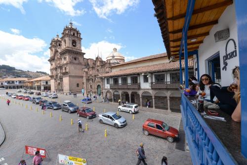 a city street with cars parked in front of a building at Hotel Plaza de Armas Cusco in Cusco