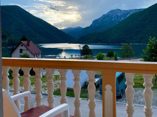 a balcony with a view of a lake and mountains at Apartment LAKEVIEW in Plužine