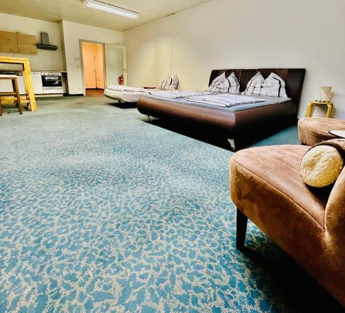 a large room with two beds and a couch at Kobra Room, 4 Personen in Spielberg