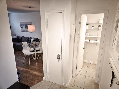 a living room with a table and a white door at Le 4 SAISONS 1 in Beaupré