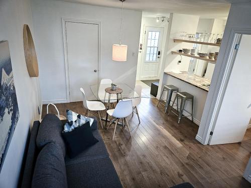 a living room with a couch and a table at Le 4 SAISONS 1 in Beaupré