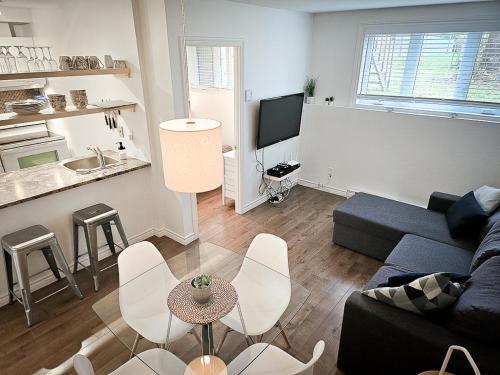 a living room with a couch and a table at Le 4 SAISONS 1 in Beaupré