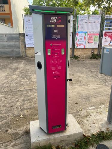 a red vending machine sitting on the side of a street at Bed & Breakfast da Giovanni in Alessano