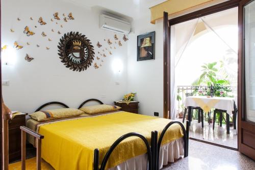 a bedroom with a bed with a yellow bedspread at Affittacamere Acquamarina in Oristano