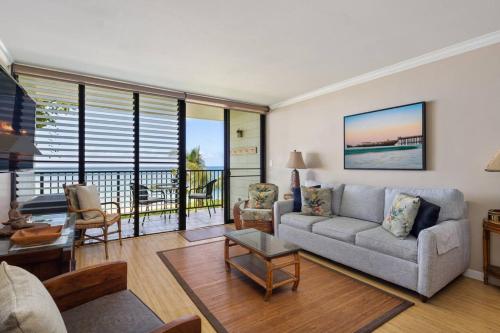a living room with a couch and a table at Hidden Jewel in Haleiwa