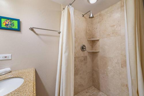 a bathroom with a shower and a sink at Hidden Jewel in Haleiwa