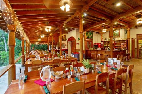 a dining room with wooden tables and chairs at Ian Anderson Caves Branch Jungle Lodge in Belmopan