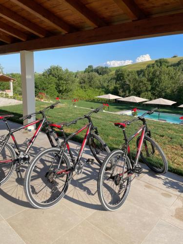 three bikes parked next to each other on a porch at Agriturismo Villa San Marco in Montefelcino