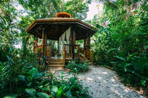 a wooden gazebo in the middle of a forest at Ian Anderson Caves Branch Jungle Lodge in Belmopan