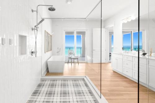 a white bathroom with a tub and a sink at Queen Of Crystal Shores Luxury Beachfront Retreat in Destin