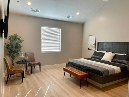 a bedroom with a bed and a table and a chair at Hurricane Hideaway in Hurricane