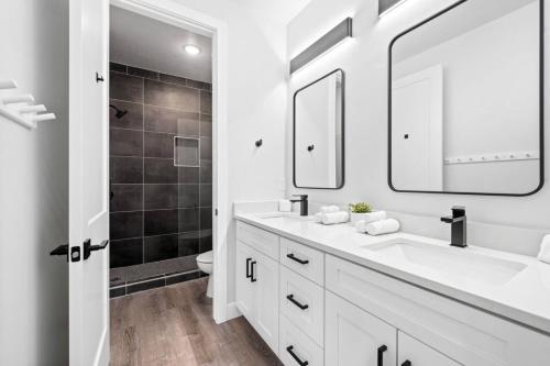 a white bathroom with a sink and a mirror at Sand Hollow Haven in Hurricane