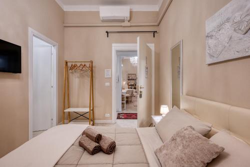 a bedroom with a large white bed with two pillows at Your House Rooms in Genova