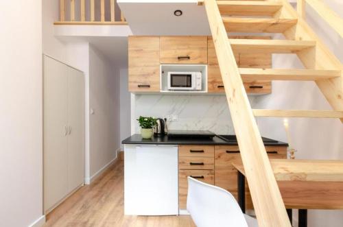 a kitchen with a counter top and a microwave at Gdańska 44 Apart in Łódź