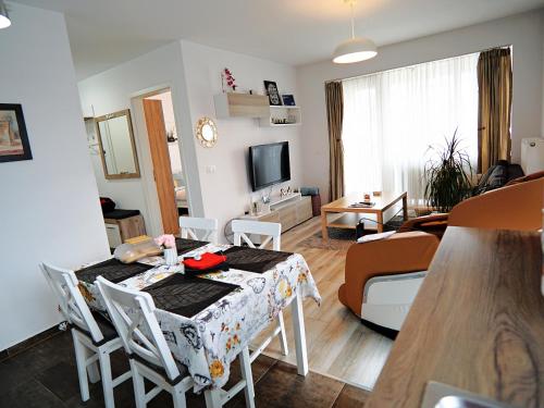 a kitchen and living room with a table and chairs at Relaxing Coresi Studio in Braşov