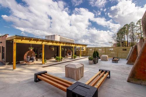 a patio with two benches and a building at Steps to Bathhouses, Restaurants, Heart of Downtown, Room # 301 in Hot Springs