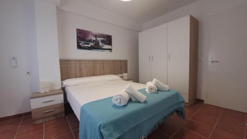 a bedroom with a bed with two towels on it at Apartamento Diputación 25 in Nerja