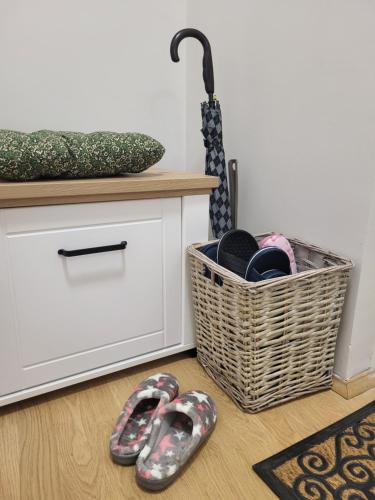 a pair of shoes and a basket with an umbrella at Regina S in Jagodina