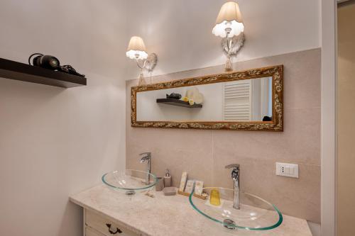a bathroom with a sink and a mirror at Your House Rooms in Genova