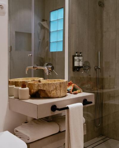 a bathroom with a sink and a shower at A Casa Brava in Santarém