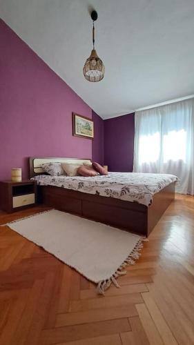 a woman laying on a bed in a bedroom at Apartman Lila in Poreč