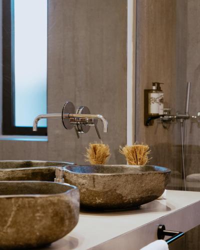 a bathroom with two sinks with hay in them at A Casa Brava in Santarém