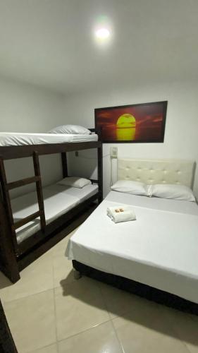 a room with two bunk beds in a room at Hotel Los Ángeles in Bello