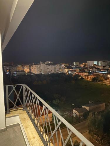 a balcony with a view of a city at night at Seaside Susanj apartment in Bar