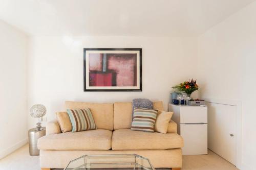 a living room with a couch and a glass table at The Retreat, Sauna & Hot Tub, Charming & Cosy Gem in Blandford Forum