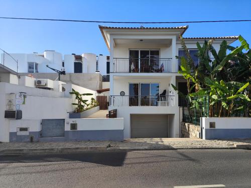 a white apartment building with a garage in front of it at PORTO SANTO MyLove in Porto Santo