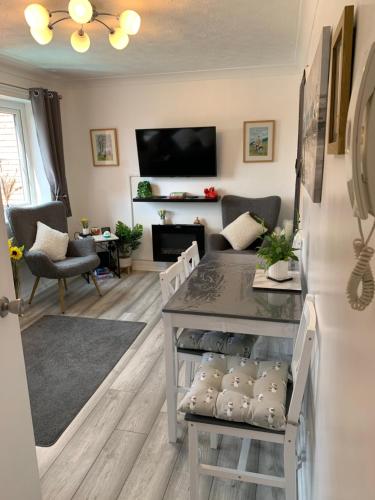 a living room with a couch and a table at Town Centre Apartment in Mold