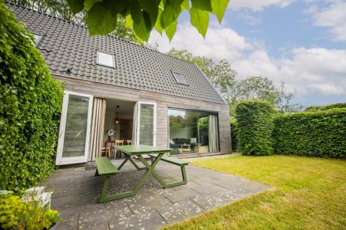 a patio with a green picnic table in the yard at Superb 90m2 Apartment with Garden - KS8A in Eindhoven