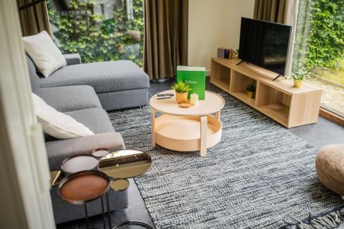 a living room with a couch and a tv at Superb 90m2 Apartment with Garden - KS8A in Eindhoven