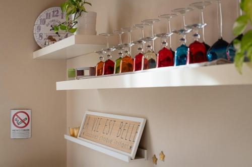 a shelf with some glass bottles on it at Your House Rooms in Genova