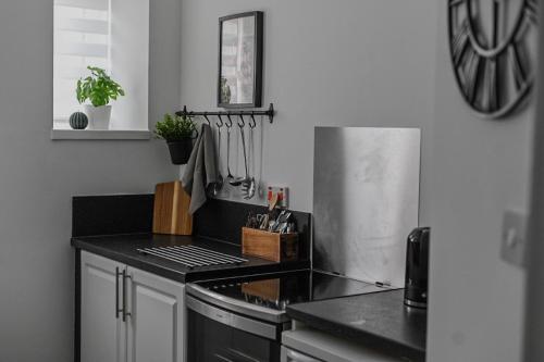 a kitchen with a stove and a black counter top at 1 Bedroom Flat in Dundee in Dundee