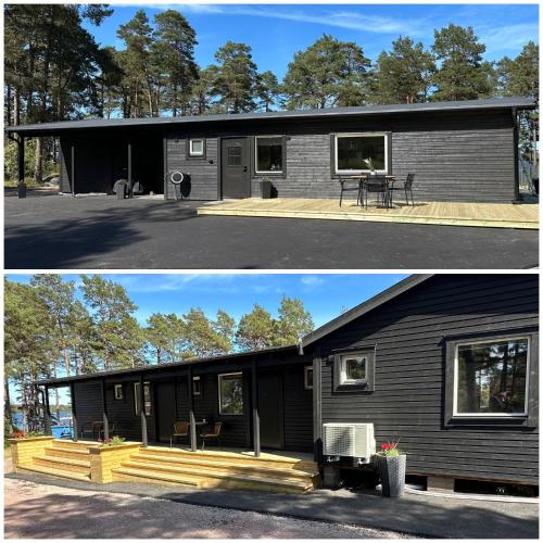 a black house with a picnic table in front of it at Perchlodge in Mönsterås