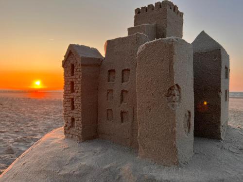 a sand castle on the beach at sunset at Strandschönheit in Wangerooge