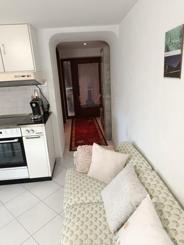 a living room with a couch in a kitchen at Casa Chiara in Intragna