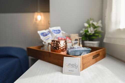 a wooden tray with a box on a table at Camere Amely in Sanremo