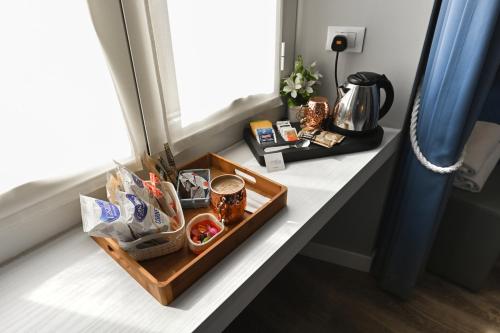 a tray with shoes and other items on a window sill at Camere Amely in Sanremo