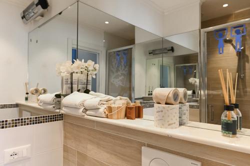 a bathroom with a counter with towels and a mirror at Camere Amely in Sanremo