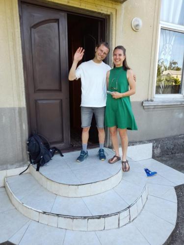 a man and a woman standing in front of a door at Guest house Enguri in Jvari