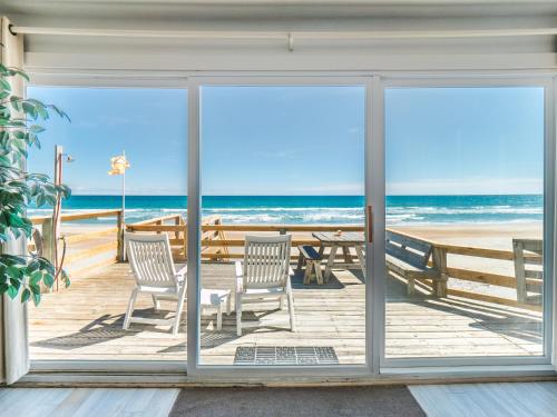 a view of the beach from a room with sliding glass doors at Mamaws Spot in Hampstead