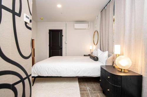 a bedroom with a bed and a table with a lamp at Walk to Bathhouses, Restaurants, Heart of Downtown, Room # 303 in Hot Springs