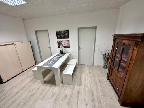 a room with a white table and a wooden cabinet at Kobra Room in Spielberg in Spielberg