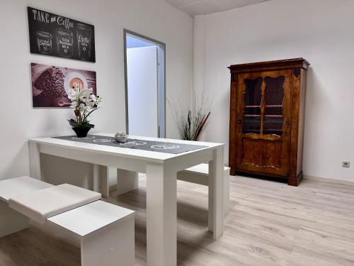 a white table and bench in a room with a window at Kobra Room in Spielberg in Spielberg