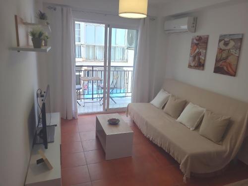 a living room with a couch and a table at Apartamento Diputación 25 in Nerja
